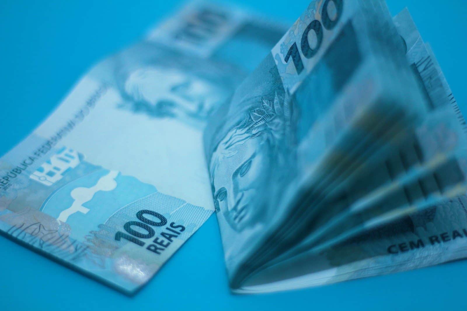 A pile of money sitting on top of a blue table