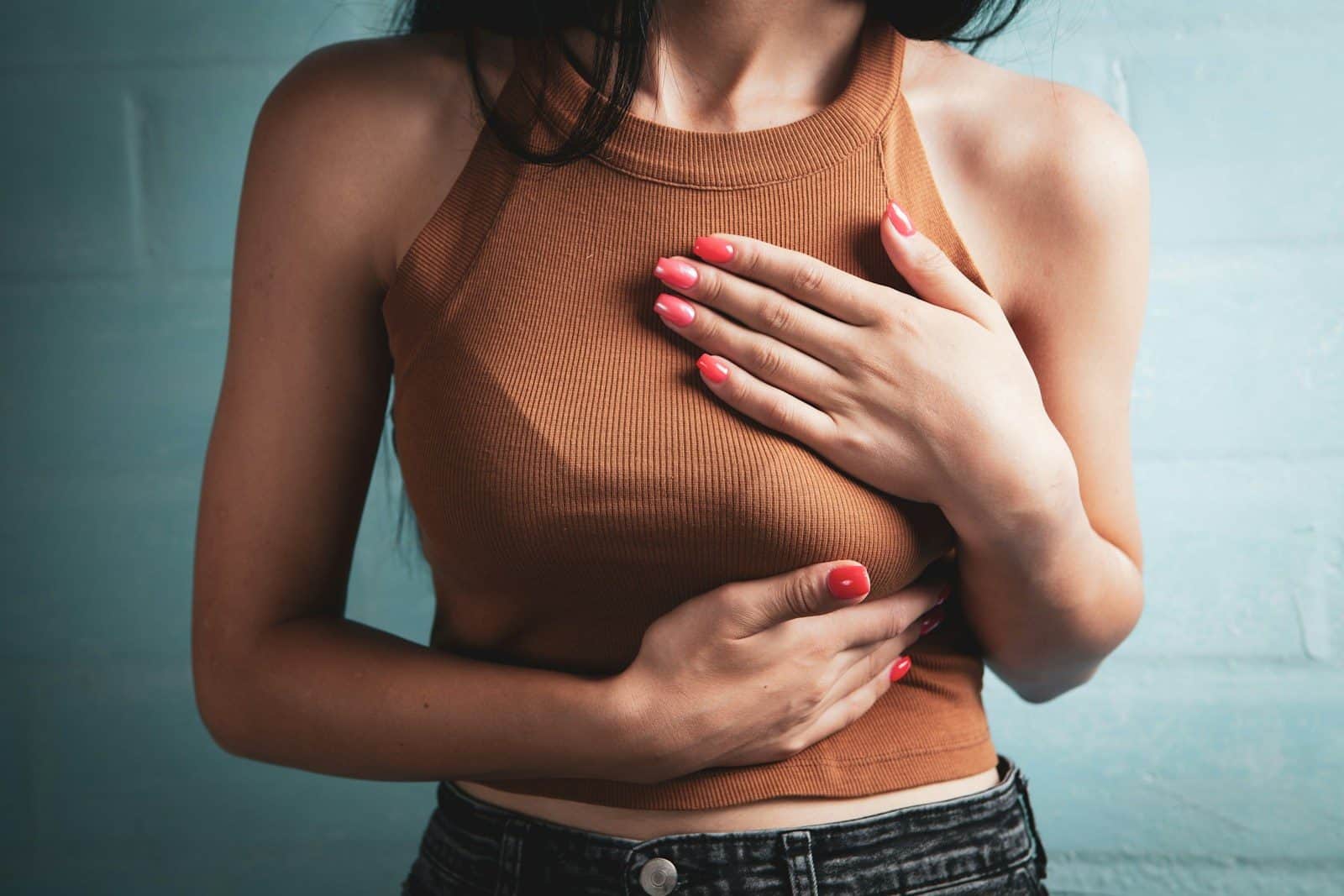 Woman holding her chest in pain